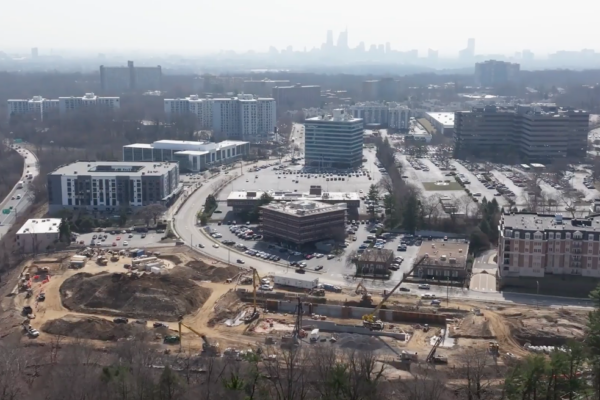 Aerial view of urban construction site and nearby buildings.