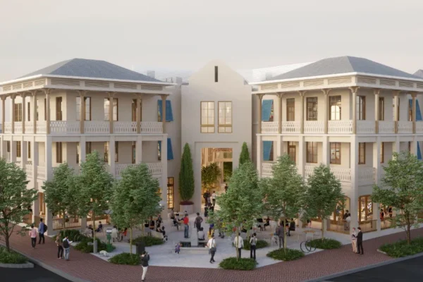 Three-story building with balconies, blue shutters, courtyard, people.